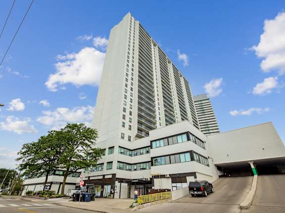 a tall white building with a street in front of it