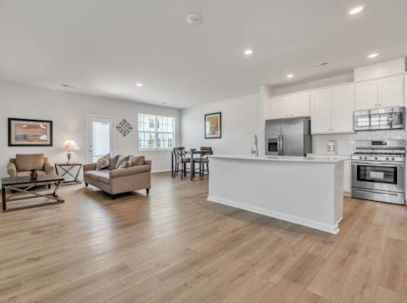 a living room with a kitchen and an open floor plan