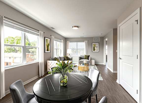A dining room with a table and chairs.