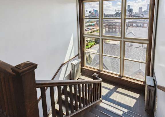 A view from a window looking out at a cityscape.