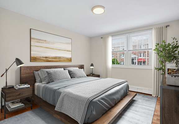A bedroom with a large bed and a painting on the wall.