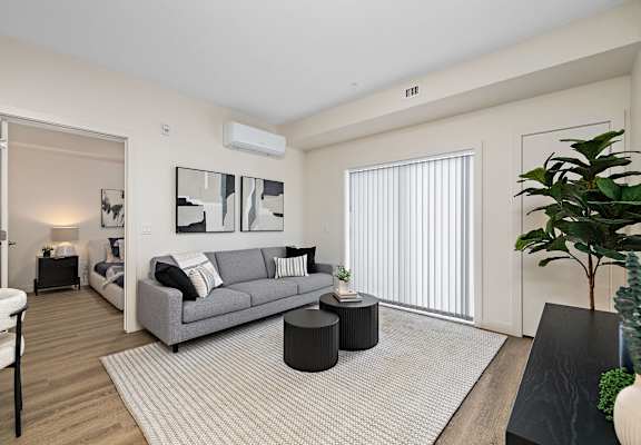 a living room with a couch and a coffee table    and a large
