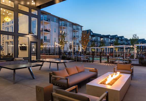 a patio with couches and tables and a fire pit at Livingston Flats Apartments, Chesterfield, VA, 23832