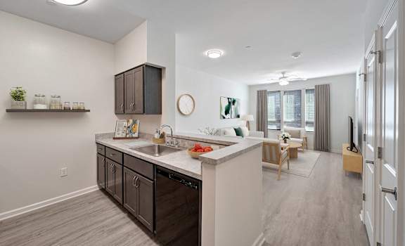 A modern kitchen with dark brown cabinets and a white countertop.