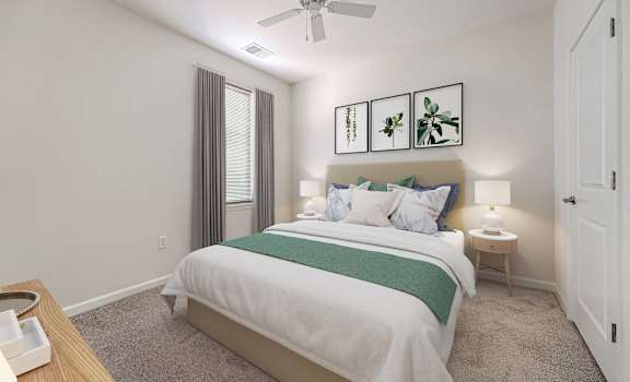 A bedroom with a bed, nightstand, and a ceiling fan.