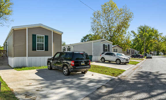A black SUV is parked in front of a house.