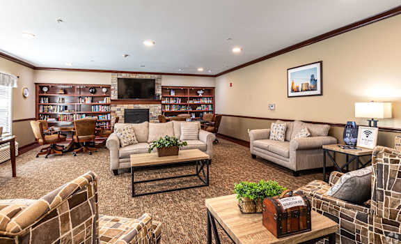 A living room with a fireplace and a bookshelf.