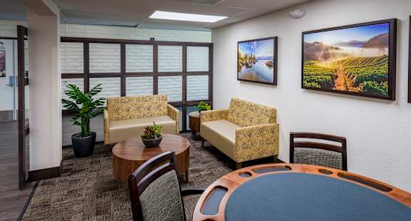 The Sierra Sunrise Senior Apartments sign lobby area, with seating and a poker table