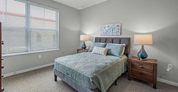 a bedroom with a bed and a ceiling fan