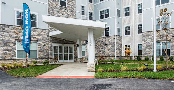 an entrance to a building with a blue flag in front of it