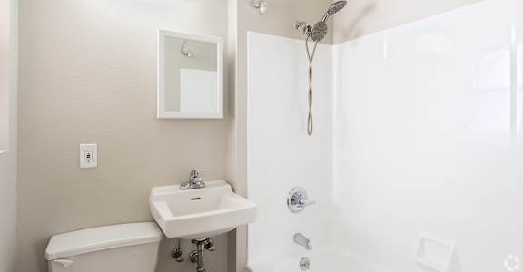 a bathroom with a shower sink and toilet