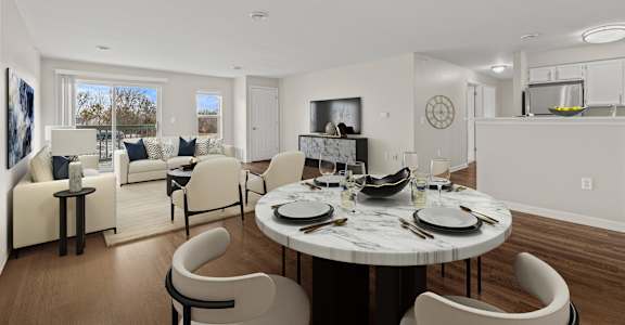 an open living room and dining room with a table and chairs