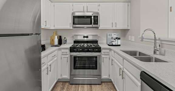 a kitchen with stainless steel appliances and white cabinets