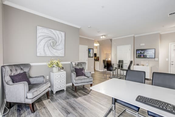 a living room with chairs and a table and a computer at Barrington Park Apartments, Manassas, VA, 20110