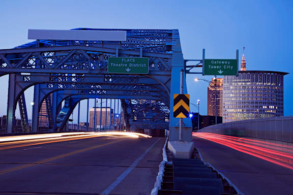 A bridge with a sign that says Flats Theatre District.