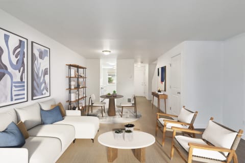 a living room with white couches and chairs and a table