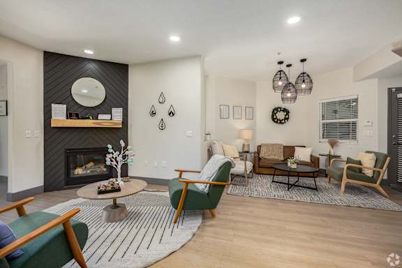 A living room with a fireplace and a green chair.