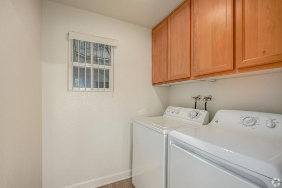 A small laundry room with a washer and dryer.