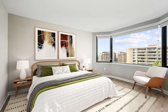 a bedroom with a large bed and a large window