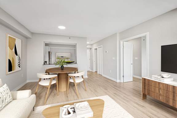 a living room and dining room with a table and chairs