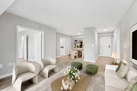 a living room with white furniture and a tv