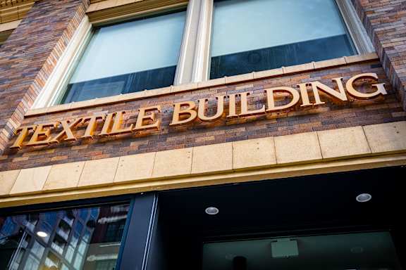 the exterior of a building with a sign on the front