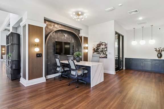 A modern office space with a wooden floor and a white reception desk.at The Liliana Apartment Homes, Pooler, GA 31322