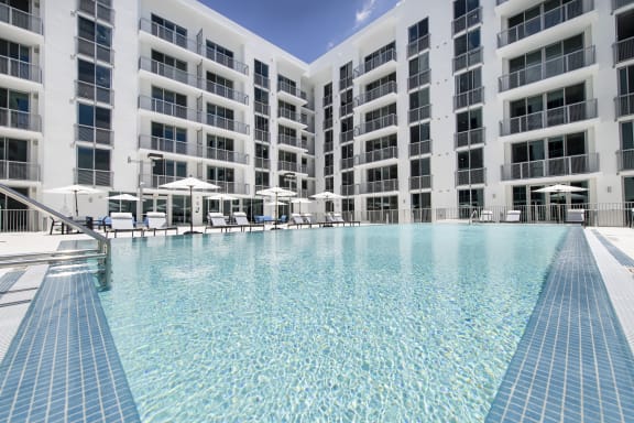 an infinity pool in front of an apartment building