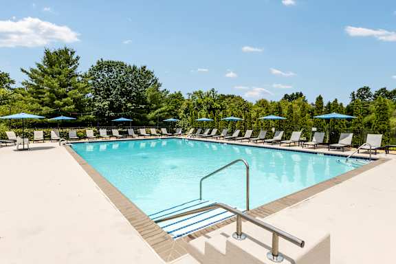 A pool with a metal ladder and a metal railing.