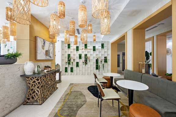A modern cafe with a white and green wall and a yellow floor.