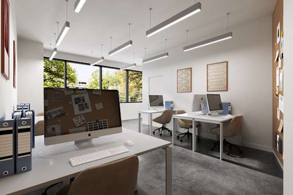 an office with a desk with a computer on it