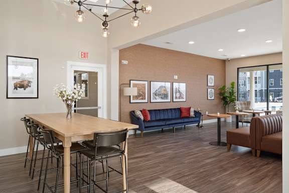 A dining area with a table and chairs.