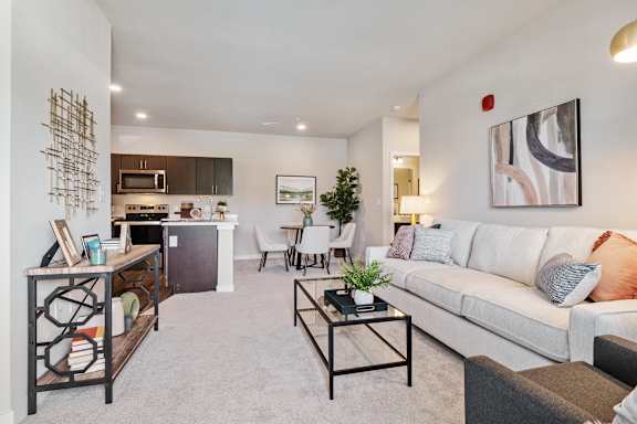A living room with a white couch and a coffee table.