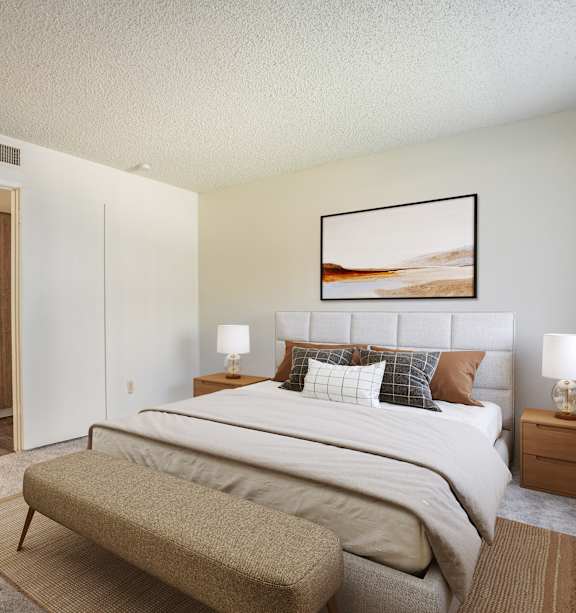 A bedroom with a large bed and a painting on the wall.