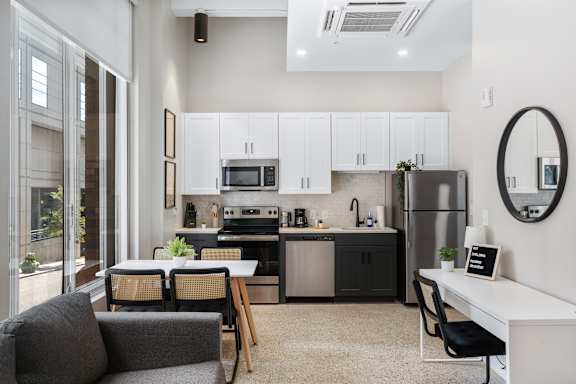 an open kitchen and living room with a table and chairs