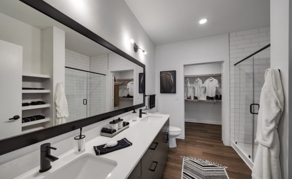 a bathroom with two sinks and a large mirror