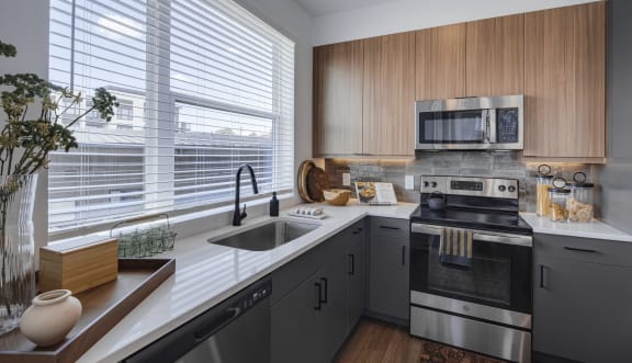 a kitchen with stainless steel appliances and wooden cabinets