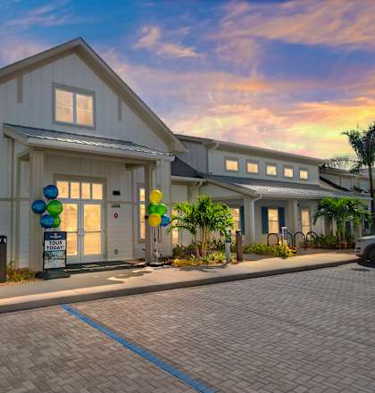 the exterior of a home with balloons and a parking lot at The Boardwalk at Tradition in Port St Lucie, FL 34987