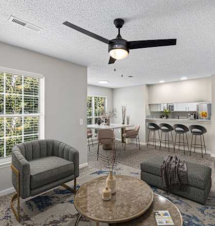 an open living room and kitchen with a ceiling fan