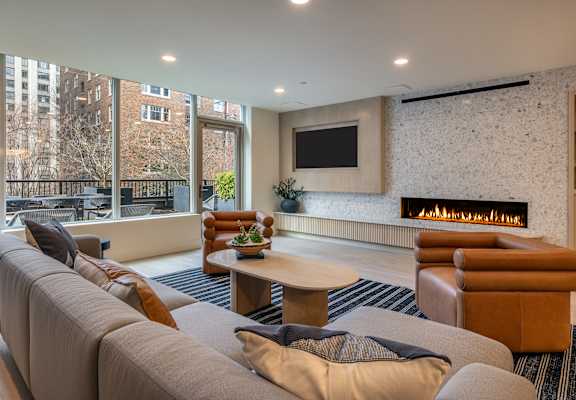 a living room with a couch and a coffee table and a fireplace