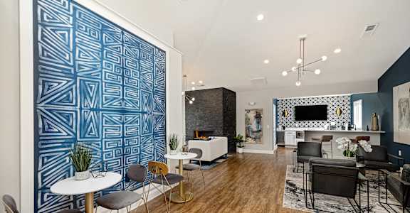 a living room with a blue and white wall and furniture