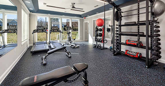 a home gym with weights and equipment and windows