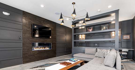 a living room with a couch and a coffee table and a fireplace