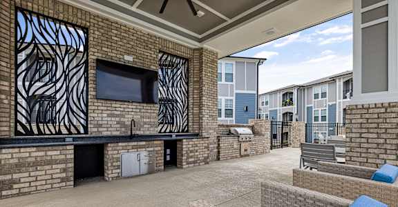 a clubhouse patio with couches and a television