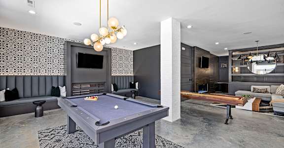 a blue pool table in a living room with a television