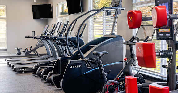 a row of exercise bikes in a gym