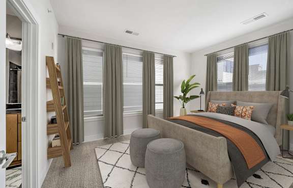 A bedroom with a large bed and a wooden ladder.