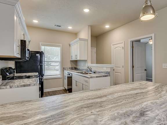 an open kitchen and living room with a table and chairs at Barrington Apartments, South Carolina