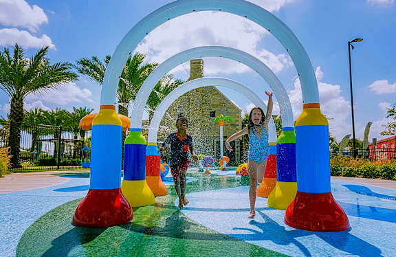 a man and a woman playing in a water park