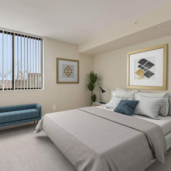 A bedroom with a large bed and a blue sofa.
